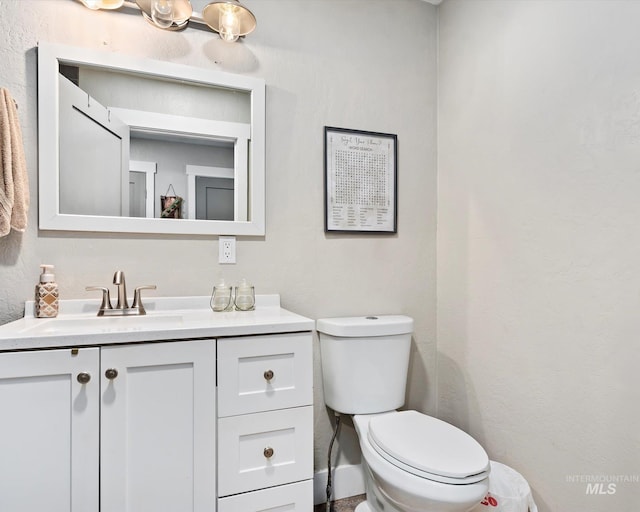 bathroom featuring toilet and vanity