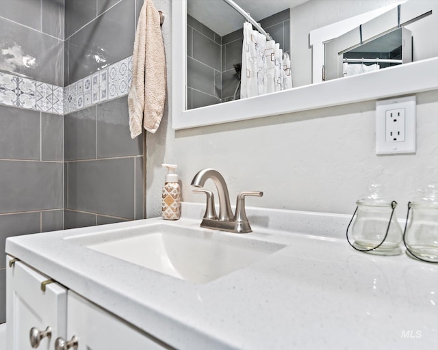 bathroom with curtained shower and vanity