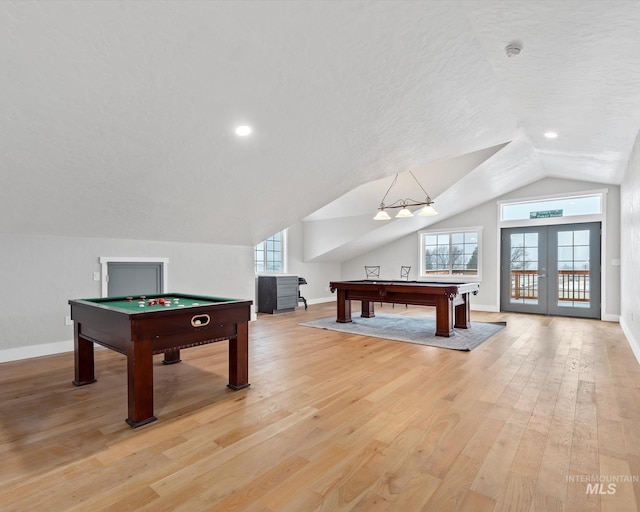 playroom with pool table, light wood-type flooring, and a textured ceiling