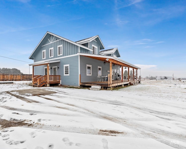 snow covered property featuring a porch