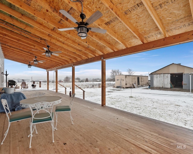 snow covered deck with a grill