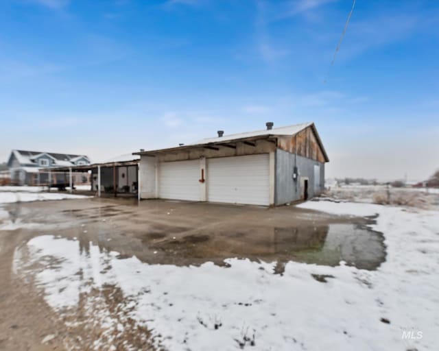 view of snow covered garage