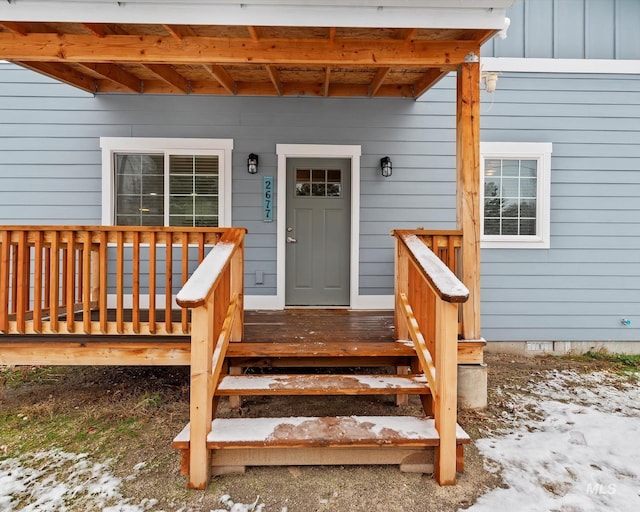 view of snow covered property entrance