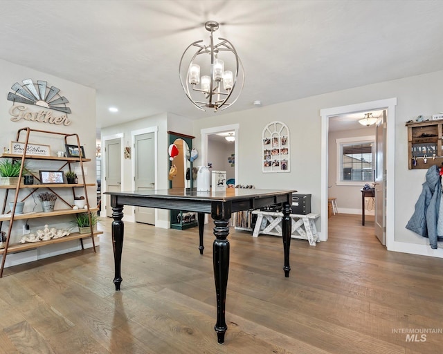 dining space with an inviting chandelier and hardwood / wood-style floors