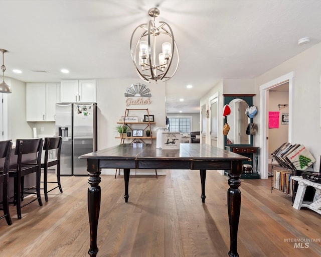 dining room with an inviting chandelier and light hardwood / wood-style floors