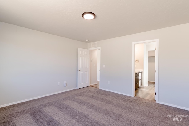 unfurnished bedroom featuring baseboards, visible vents, and carpet floors