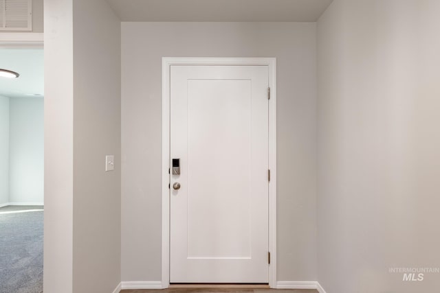 doorway featuring baseboards and visible vents