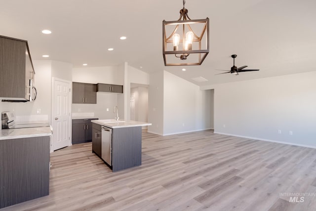 kitchen featuring light wood-style flooring, a sink, lofted ceiling, ceiling fan with notable chandelier, and appliances with stainless steel finishes