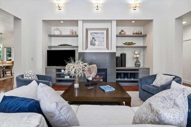 356 E Lake Briar Ln, Eagle, ID 83616 - living area featuring wood finished floors, built in shelves, and a tiled fireplace