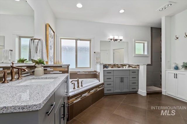 356 E Lake Briar Ln, Eagle, ID 83616 - bathroom with healthy amount of natural light, two vanities, a garden tub, tile patterned floors, and recessed lighting
