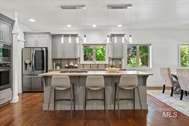 356 E Lake Briar Ln, Eagle, ID 83616 - kitchen with appliances with stainless steel finishes, gray cabinets, a kitchen island, backsplash, and recessed lighting