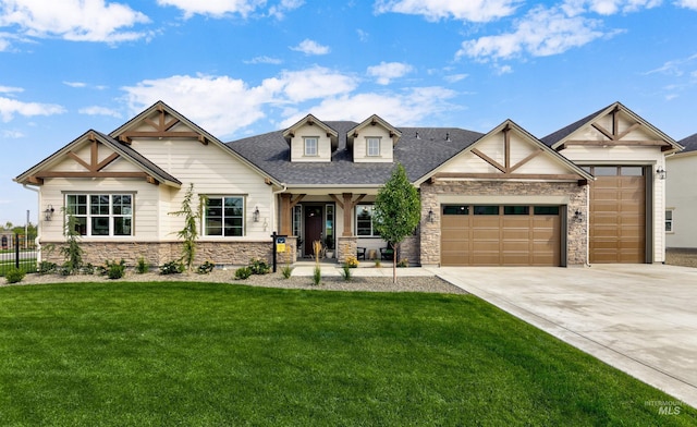 view of front of property with stone siding, an attached garage, driveway, and a shingled roof
