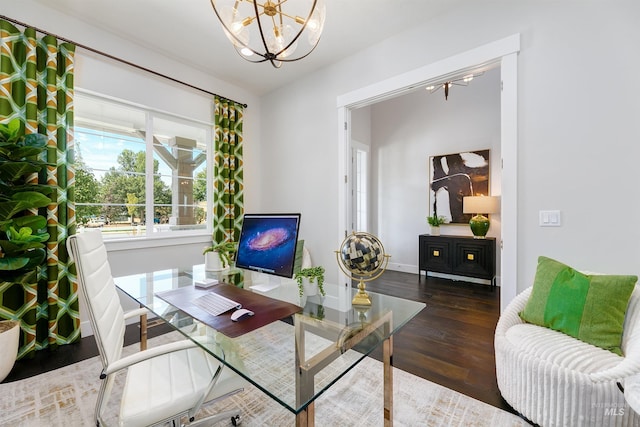 home office with a chandelier, wood finished floors, and baseboards