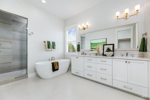 bathroom with a shower stall, double vanity, and a soaking tub