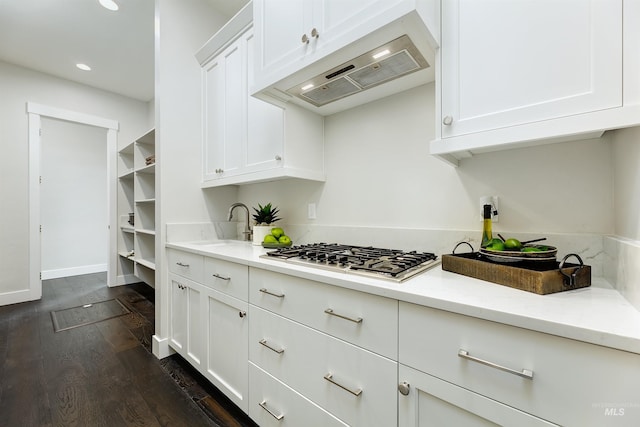 kitchen with stainless steel gas cooktop, under cabinet range hood, dark wood finished floors, white cabinets, and recessed lighting