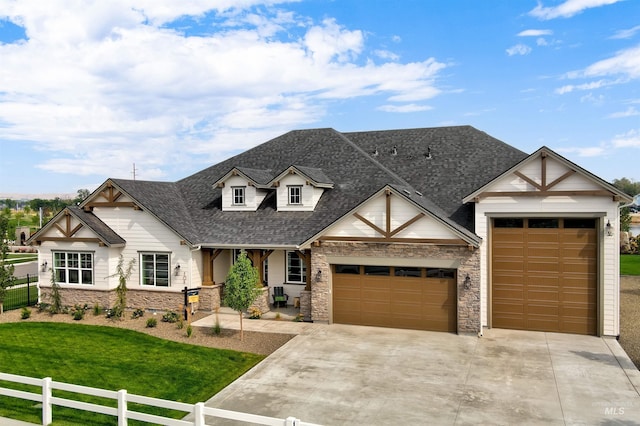 view of front facade featuring a garage, a shingled roof, stone siding, a porch, and driveway