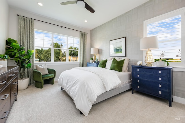 bedroom featuring light colored carpet, baseboards, recessed lighting, and ceiling fan