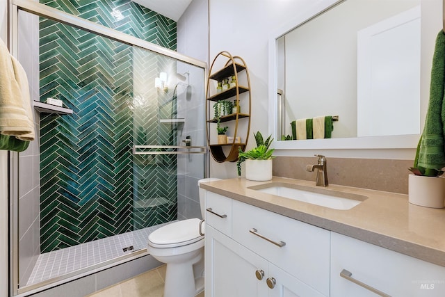 bathroom with toilet, vanity, a shower stall, and tile patterned flooring