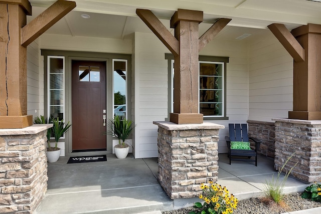 view of exterior entry with covered porch
