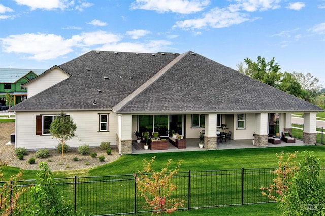 rear view of house featuring outdoor lounge area, a shingled roof, and a patio