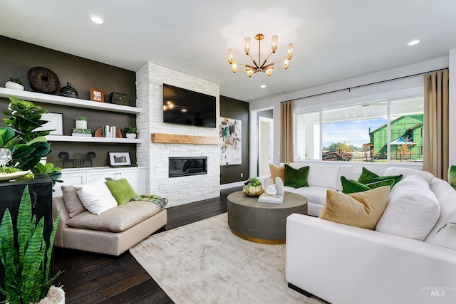 living room with wood finished floors, a chandelier, a fireplace, and recessed lighting