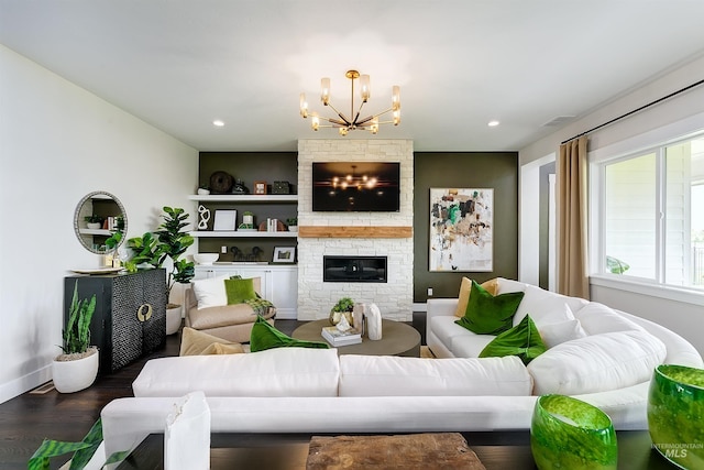 living room with a chandelier, wood finished floors, a fireplace, recessed lighting, and baseboards