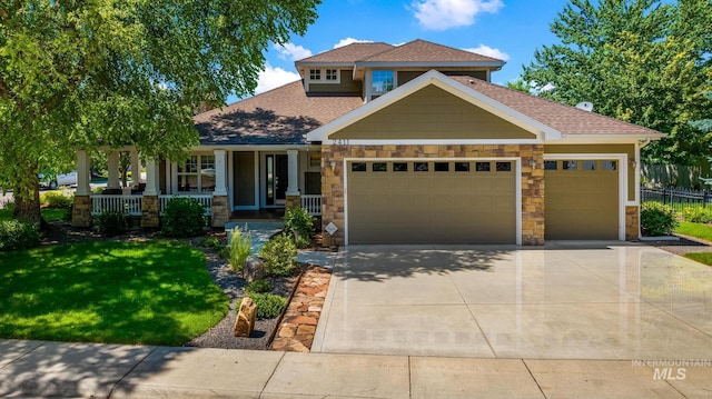 2411 S Marypost, Eagle, ID 83616 - craftsman house featuring covered porch, an attached garage, stone siding, a front lawn, and concrete driveway