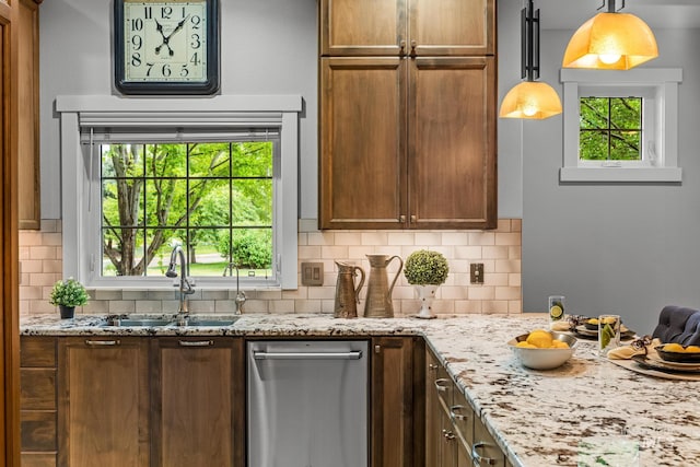 2411 S Marypost, Eagle, ID 83616 - kitchen featuring decorative backsplash, light stone countertops, pendant lighting, dishwasher, and brown cabinets