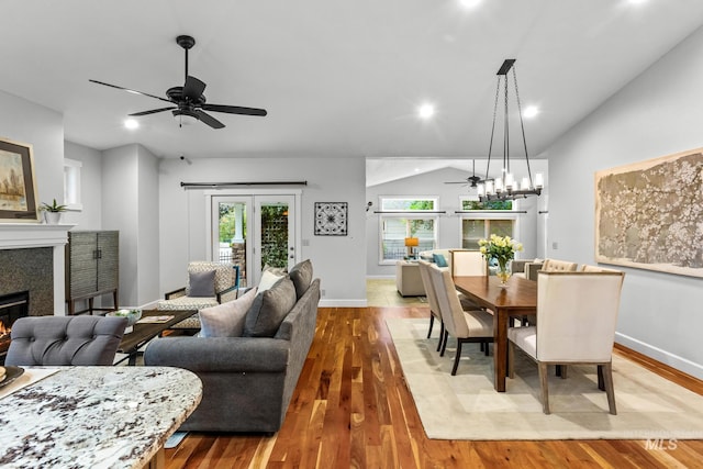 2411 S Marypost, Eagle, ID 83616 - dining room featuring a ceiling fan, a glass covered fireplace, wood finished floors, vaulted ceiling, and recessed lighting