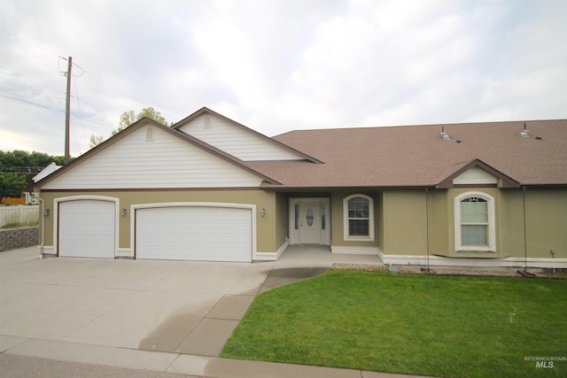 view of front of house with driveway, a garage, a front lawn, and roof with shingles