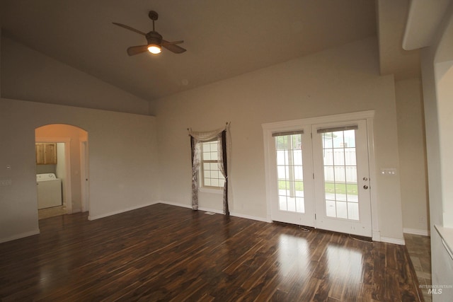 unfurnished room featuring arched walkways, wood finished floors, ceiling fan, high vaulted ceiling, and washer / clothes dryer