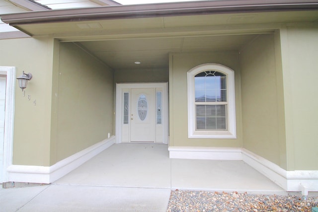 property entrance with stucco siding