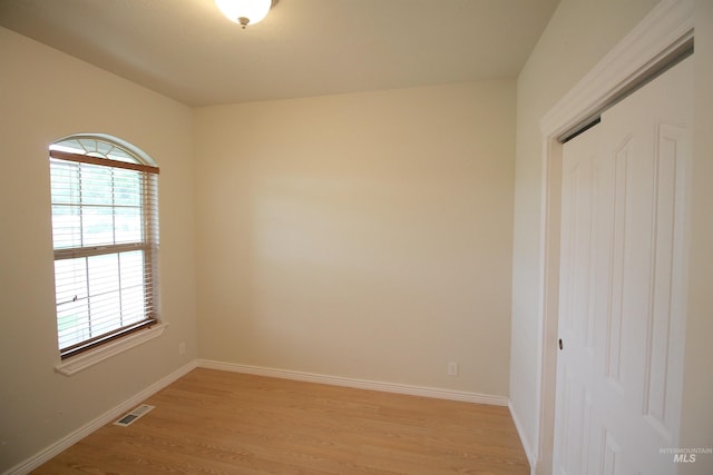 unfurnished room featuring light wood-style flooring and baseboards