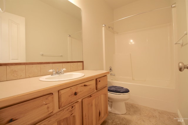 bathroom featuring toilet, tub / shower combination, vanity, and tile patterned floors