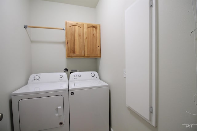 washroom featuring cabinet space and washer and dryer