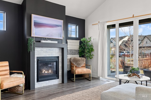 10148 Irongate Dr, Nampa, ID 83687 - living area featuring lofted ceiling, wood finished floors, and a brick fireplace