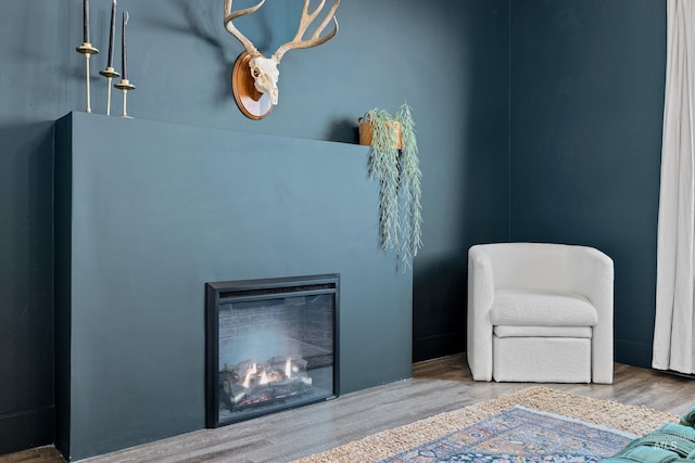 10148 Irongate Dr, Nampa, ID 83687 - sitting room with a glass covered fireplace and wood finished floors