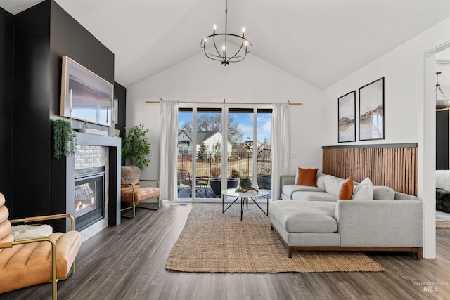 10148 Irongate Dr, Nampa, ID 83687 - living area with wood finished floors, a brick fireplace, high vaulted ceiling, and an inviting chandelier