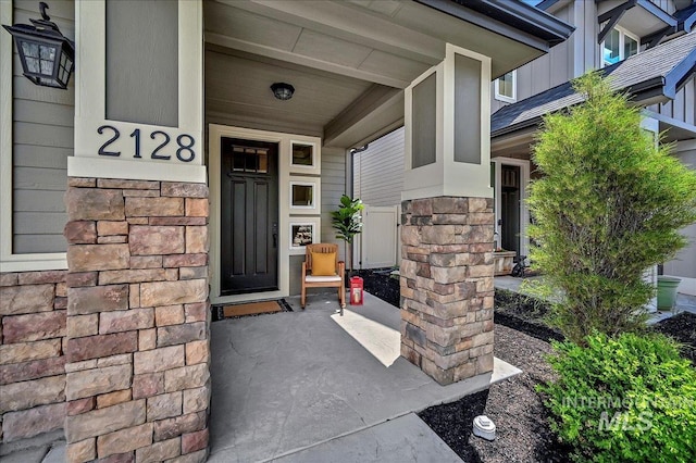 2128 N Woodcreek St, Boise, ID 83704 - doorway to property with covered porch