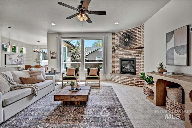 2128 N Woodcreek St, Boise, ID 83704 - living room with a brick fireplace, a ceiling fan, a chandelier, and recessed lighting