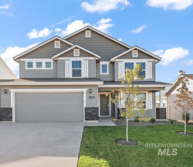 craftsman-style home with a garage and a front lawn