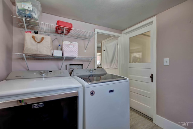 412 6th Ave N, Twin Falls, ID 83301 - laundry room featuring washer and clothes dryer and light wood-style floors