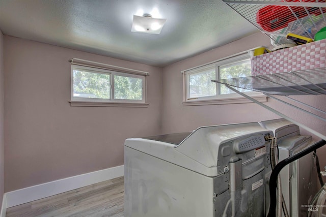 412 6th Ave N, Twin Falls, ID 83301 - laundry area featuring light wood-style floors, plenty of natural light, and washing machine and clothes dryer