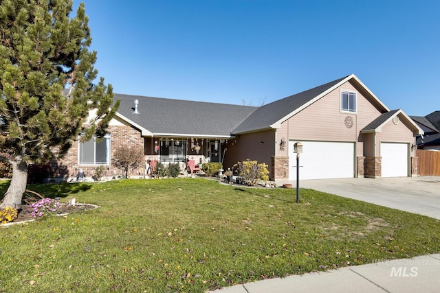 view of front of property with a porch, a front yard, brick siding, and driveway