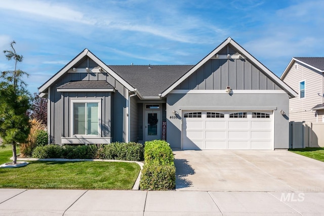 view of front of house with driveway, a garage, a front lawn, and board and batten siding