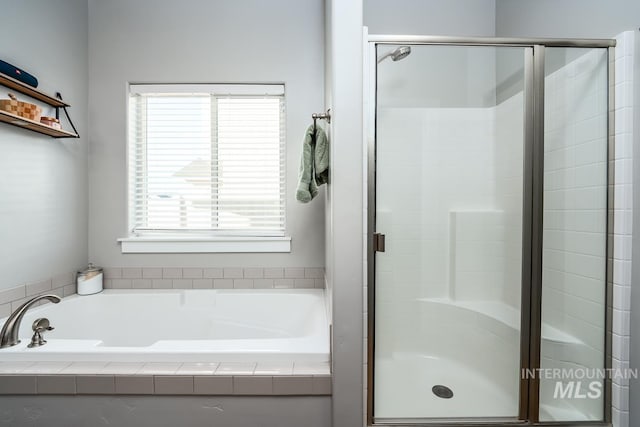 full bath featuring a stall shower and a bath