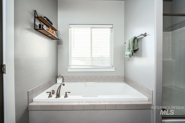 full bathroom with a shower and a bath