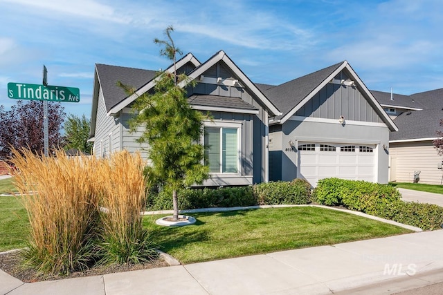 view of front of property featuring a garage, driveway, a shingled roof, board and batten siding, and a front yard