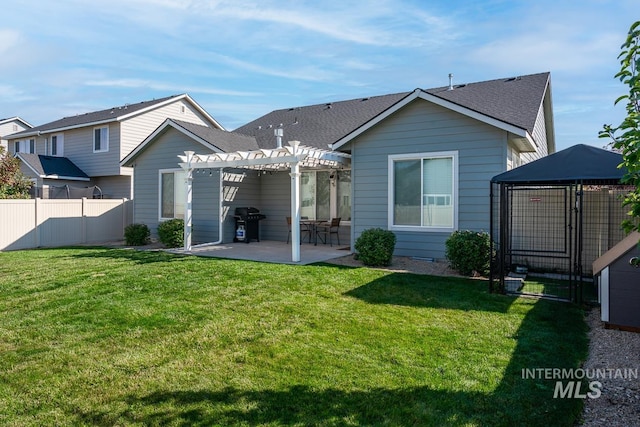 rear view of house with a yard, fence, a pergola, and a patio