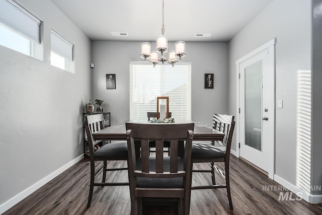 dining room featuring an inviting chandelier, dark wood finished floors, visible vents, and baseboards